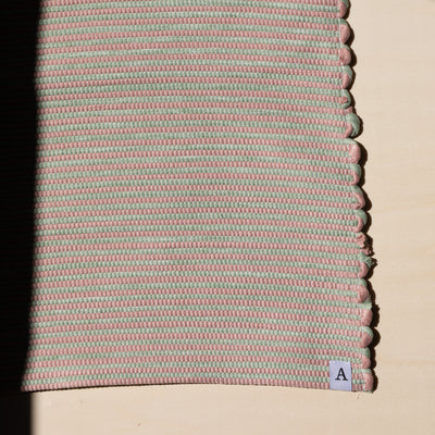 Close-up dans la lumière du soleil tapis de bain rayé en rose et vert menthe