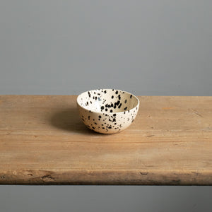 Petit snack bowl avec glaçage couleur crème et points noirs parfait pour les noix et les dips