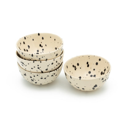 Quatre petits snack bols empilés les uns sur les autres en Black Dots sur fond blanc